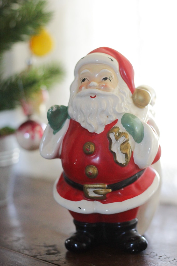 A vintage ceramic santa that I have had since childhood with mama's chicken pox tree showing in the background.